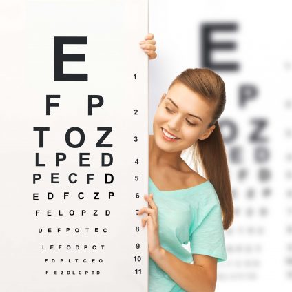 woman peaking around eye chart